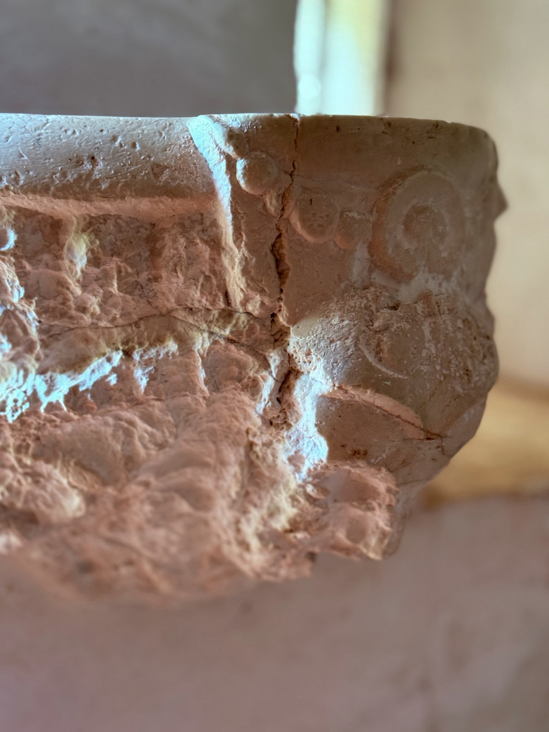 Carved stone font inside the Chapelle Saint-Saturnin near Saint-Cézaire-sur-Siagne, worn smooth by centuries of hands